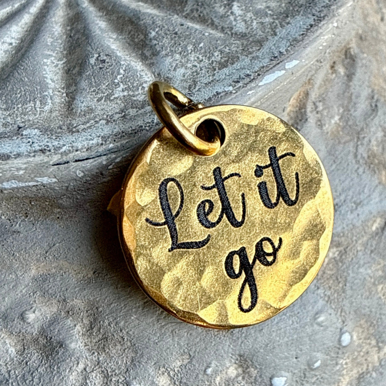 Let it go engraved on a gold hammered charm