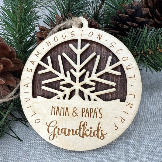 Wood snowflake ornament personalized with grandchildren’s names for grandparents.