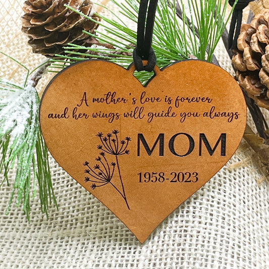 in memory oof mom heart-shaped leather ornament with engraved text and floral design.