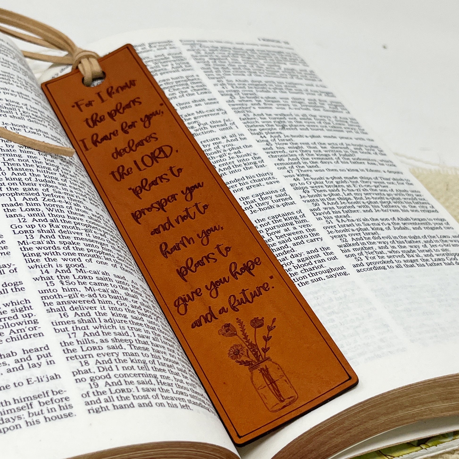 Brown leather scripture Jeremiah 29:11 bookmark with engraved text on an open book