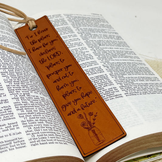 Brown leather scripture Jeremiah 29:11 bookmark with engraved text on an open book